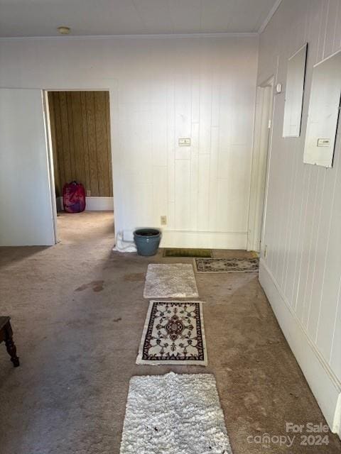 corridor with carpet and crown molding