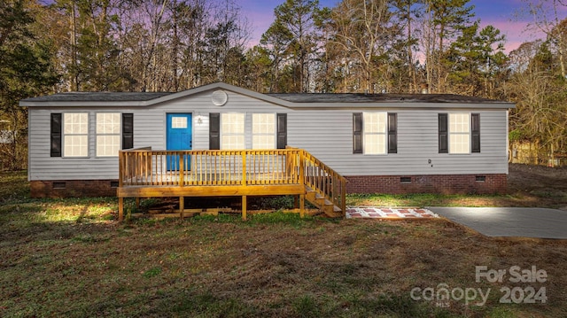 view of front of house featuring a patio area and a wooden deck