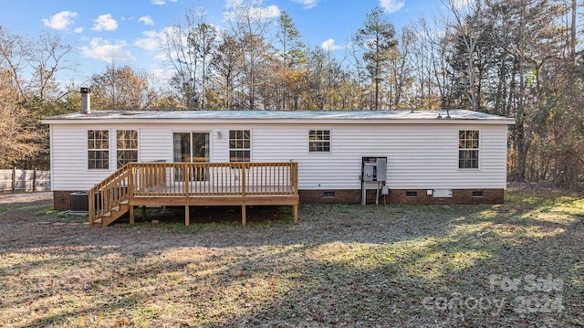 back of property with a yard, central AC unit, and a wooden deck