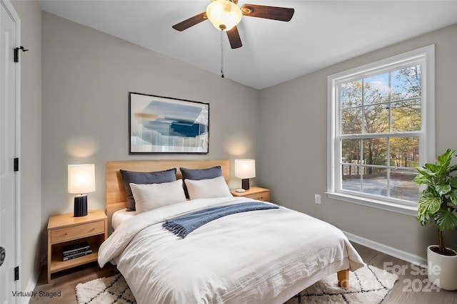 bedroom with wood-type flooring and ceiling fan