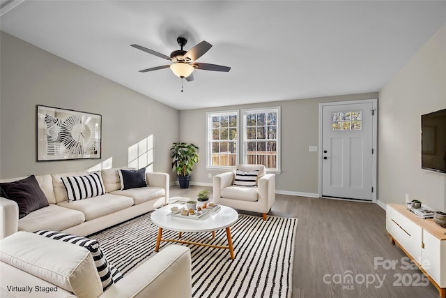 living room with ceiling fan and light hardwood / wood-style floors