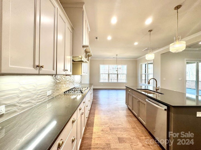 kitchen with a large island, sink, white cabinets, and appliances with stainless steel finishes