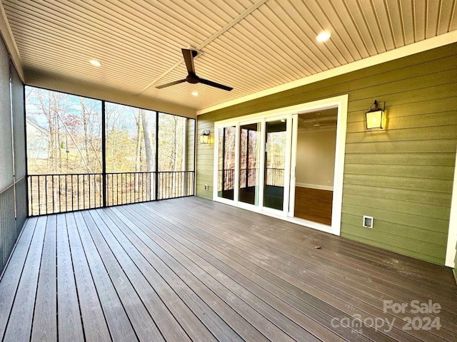 unfurnished sunroom with ceiling fan and wooden ceiling