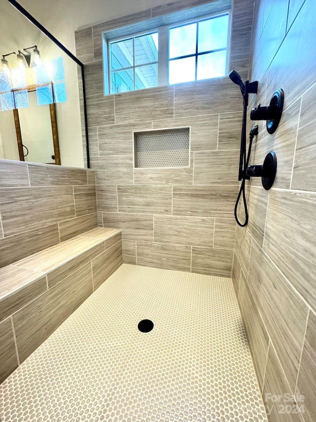 bathroom with a tile shower