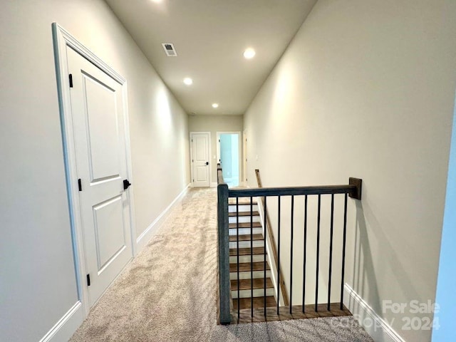 hallway with carpet floors