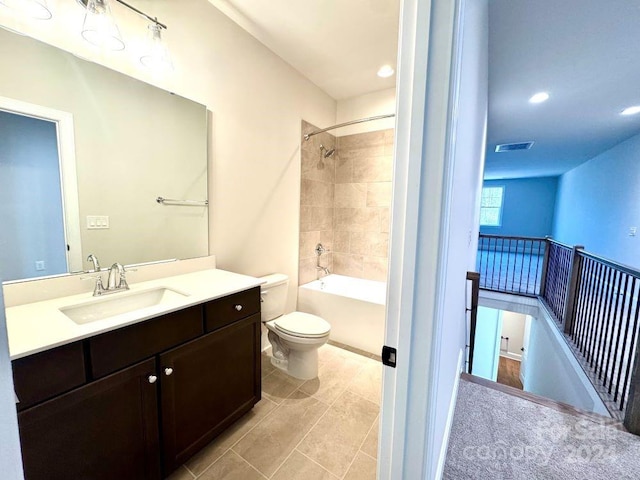 full bathroom with tile patterned floors, toilet, vanity, and tiled shower / bath