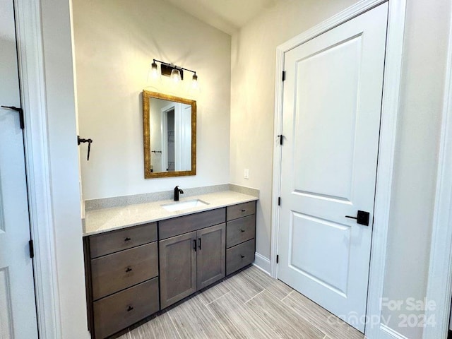 bathroom featuring hardwood / wood-style floors and vanity