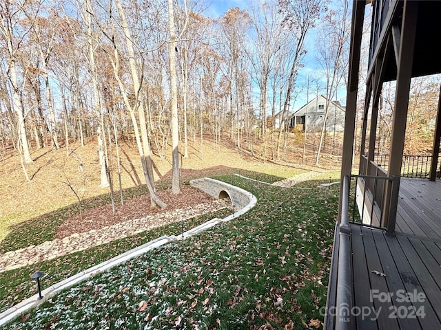 view of yard featuring a wooden deck