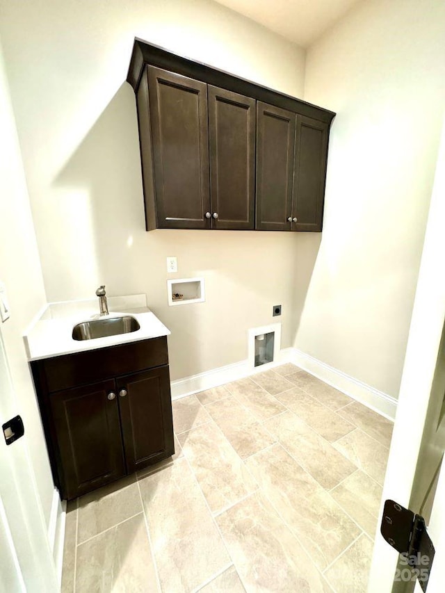 laundry area featuring cabinet space, baseboards, hookup for an electric dryer, washer hookup, and a sink