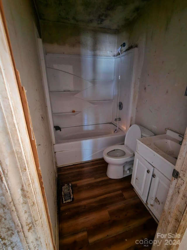 full bathroom featuring hardwood / wood-style flooring, vanity, toilet, and bathtub / shower combination