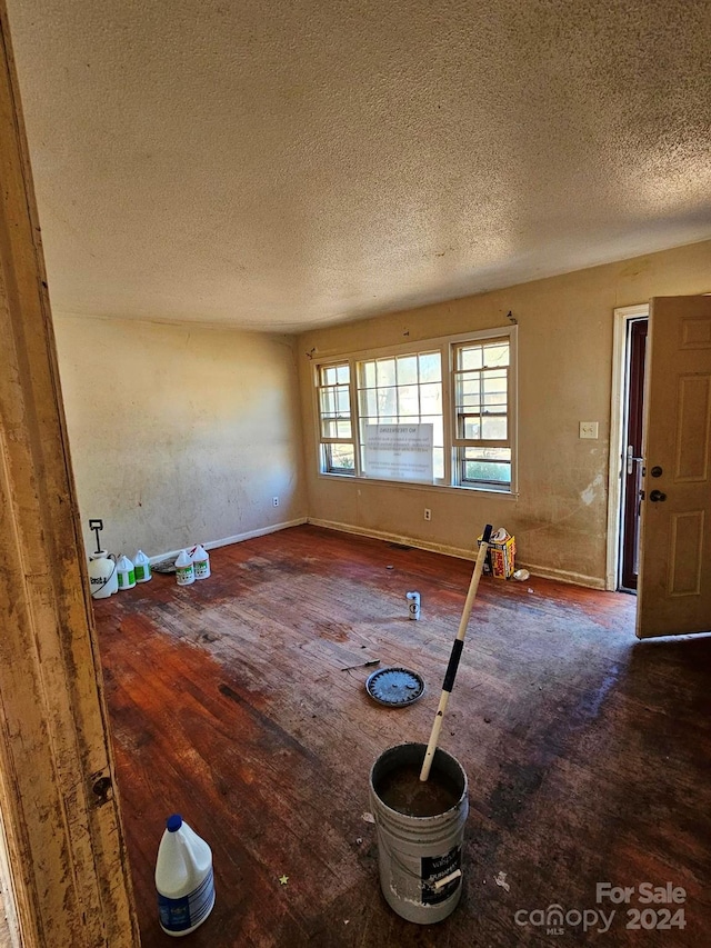 interior space with hardwood / wood-style floors and a textured ceiling