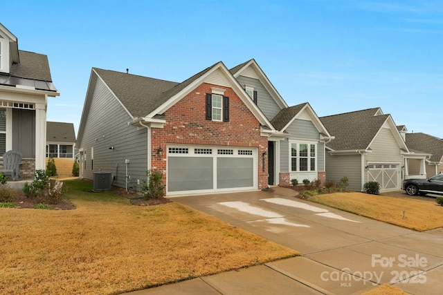 craftsman-style home featuring central AC unit, a garage, and a front lawn