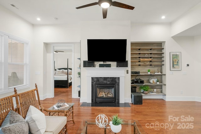 living room with hardwood / wood-style flooring and ceiling fan