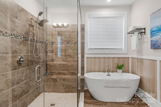 bathroom featuring shower with separate bathtub