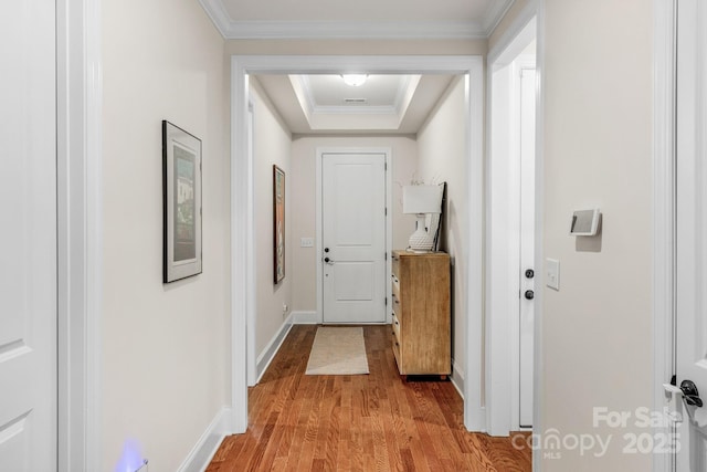 doorway to outside with light wood-type flooring and crown molding