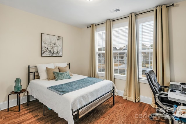 bedroom with dark wood-type flooring