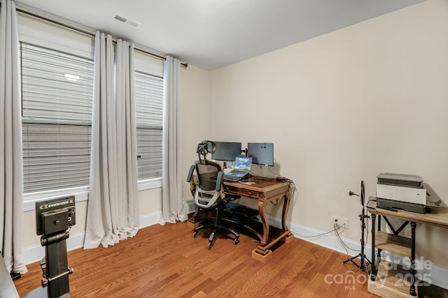 office space with light hardwood / wood-style flooring