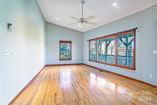 empty room with light hardwood / wood-style floors, vaulted ceiling, and ceiling fan