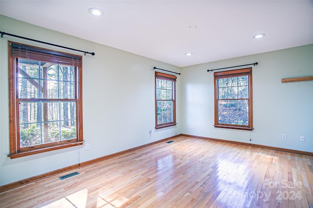 unfurnished room featuring light hardwood / wood-style flooring