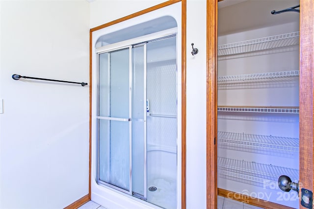 bathroom with tile patterned flooring and an enclosed shower