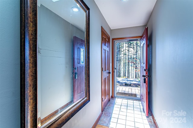 doorway to outside featuring light tile patterned floors