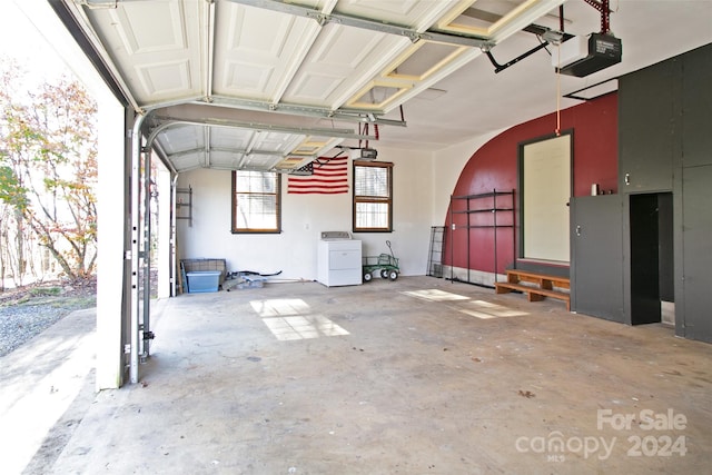 garage with washer / dryer and a garage door opener