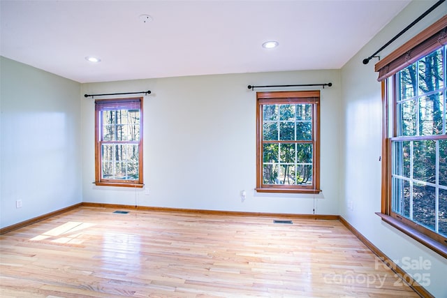 unfurnished room with visible vents, recessed lighting, baseboards, and light wood finished floors