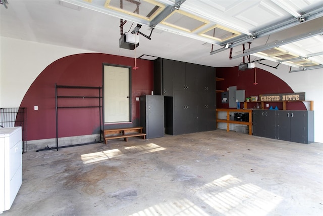 garage featuring washer / clothes dryer and a garage door opener