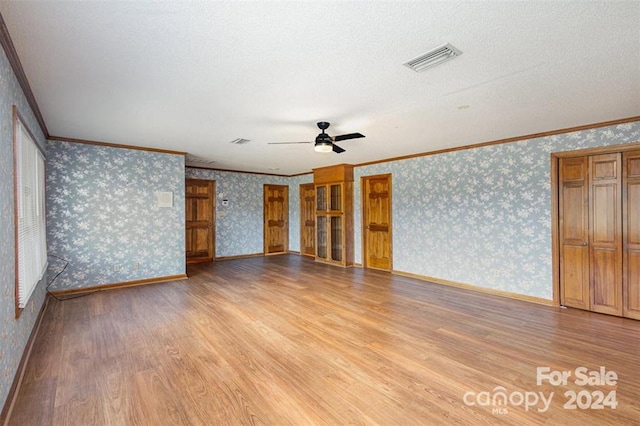 spare room featuring ceiling fan, crown molding, a textured ceiling, and light hardwood / wood-style flooring