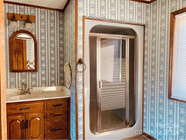 bathroom featuring vanity, an enclosed shower, and ornamental molding