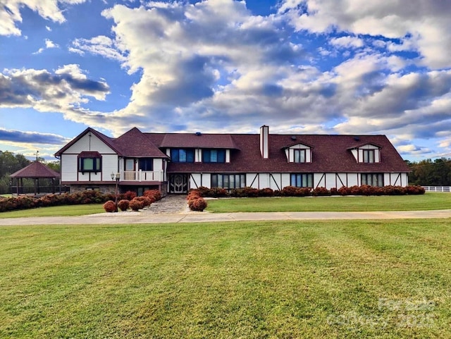 english style home with a front yard