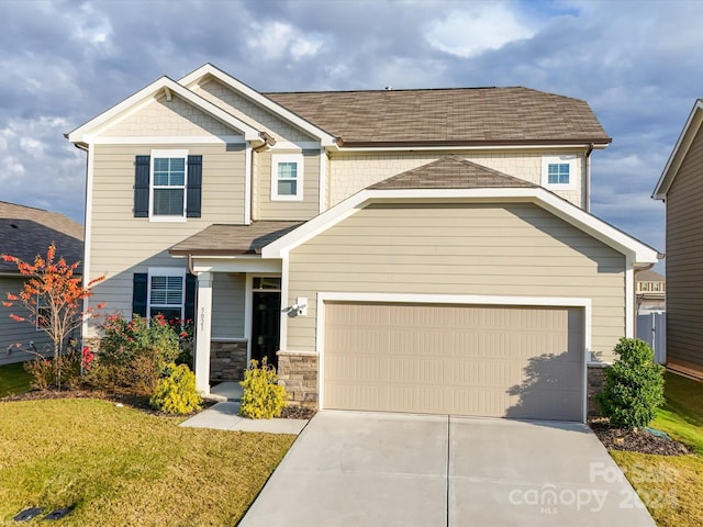 craftsman-style house featuring a garage and a front yard