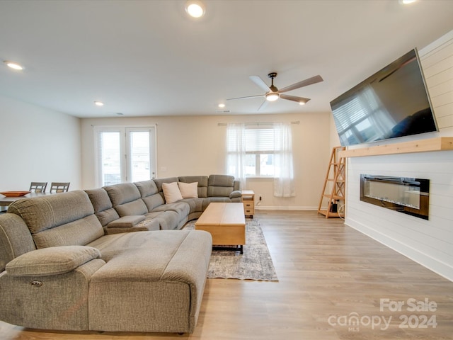 living room with ceiling fan, a healthy amount of sunlight, and wood-type flooring