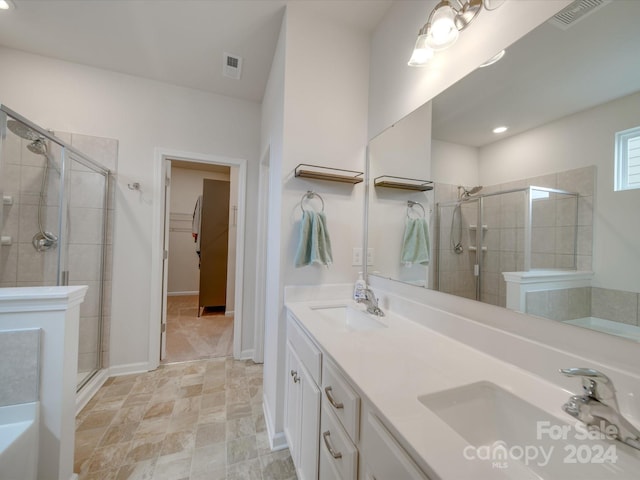 bathroom featuring vanity and a shower with door