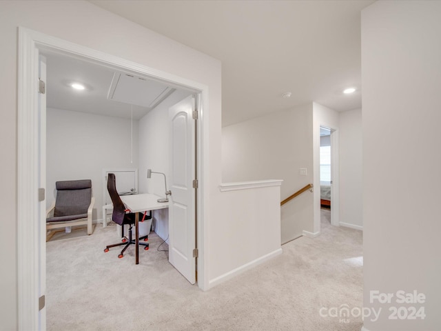 hall with light colored carpet