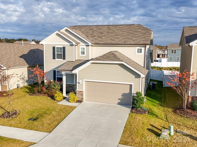 view of front of home featuring a garage, a front lawn, and cooling unit