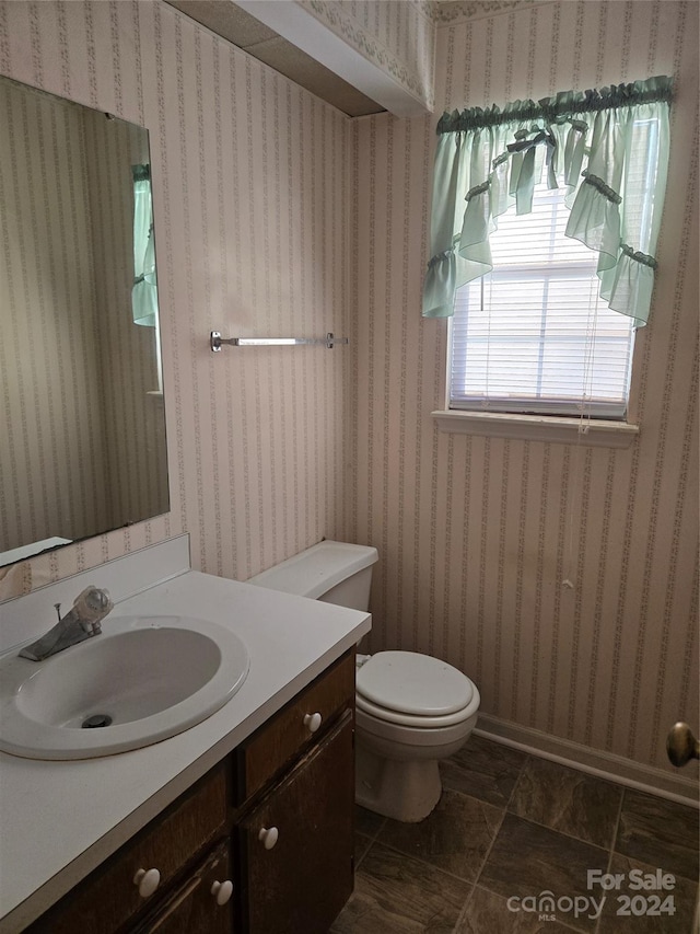 bathroom featuring vanity and toilet