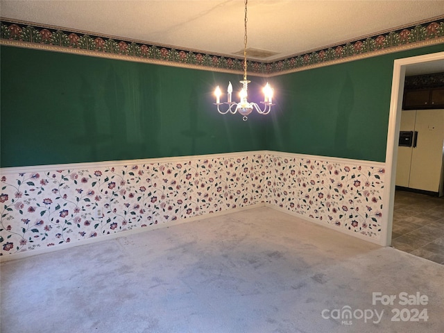 unfurnished dining area featuring carpet, a textured ceiling, and a notable chandelier