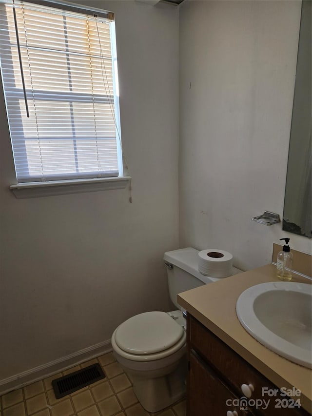 bathroom featuring tile patterned floors, vanity, and toilet