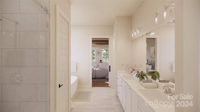 bathroom featuring a washtub and vanity