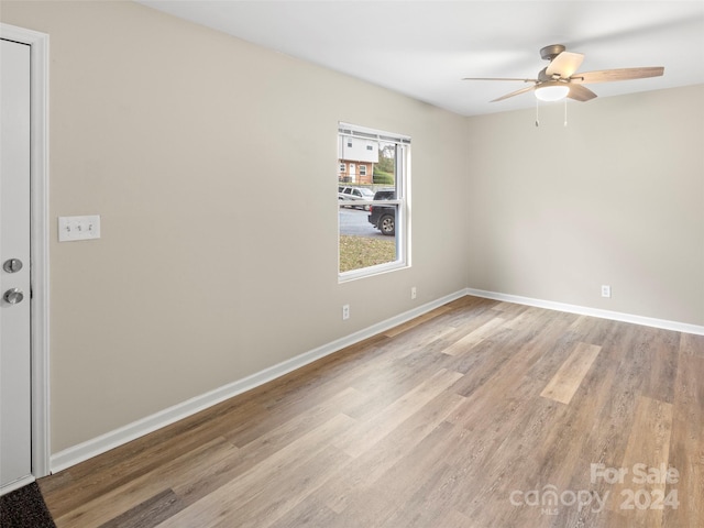 unfurnished room with ceiling fan and light wood-type flooring