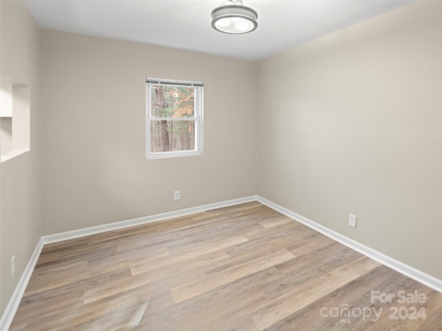 empty room with light hardwood / wood-style flooring