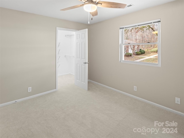 carpeted empty room with ceiling fan