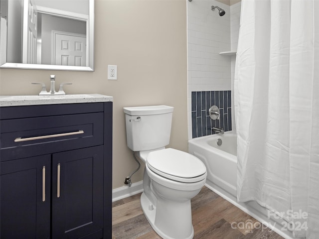 full bathroom with hardwood / wood-style floors, vanity, toilet, and shower / bathtub combination with curtain