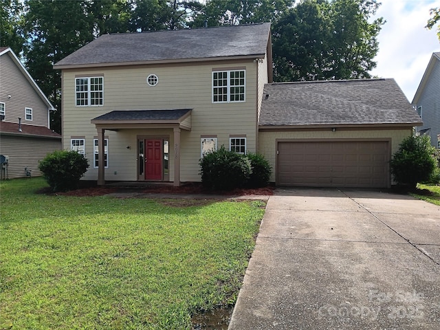 view of front of house with a front yard and a garage