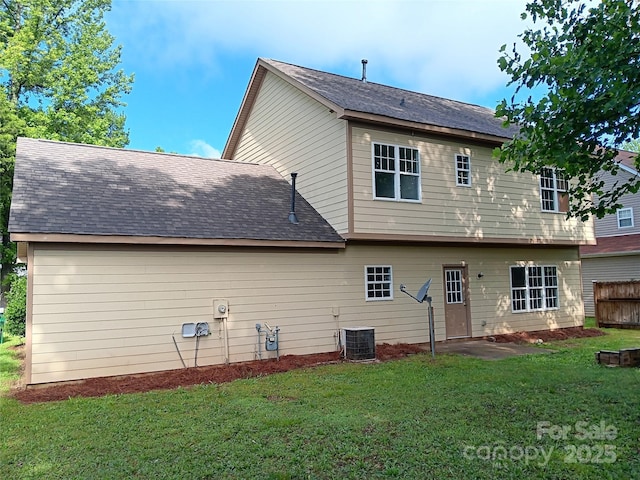 back of house with a lawn and central AC