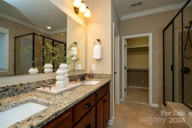 bathroom featuring vanity, tile patterned floors, walk in shower, and ornamental molding