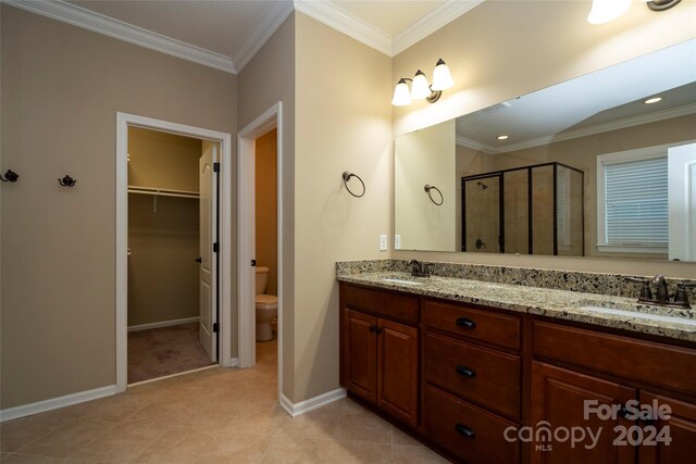 bathroom with vanity, toilet, an enclosed shower, and crown molding