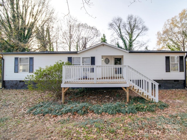 rear view of house featuring a deck