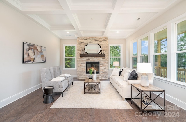 living room with hardwood / wood-style floors, coffered ceiling, ornamental molding, a fireplace, and beam ceiling